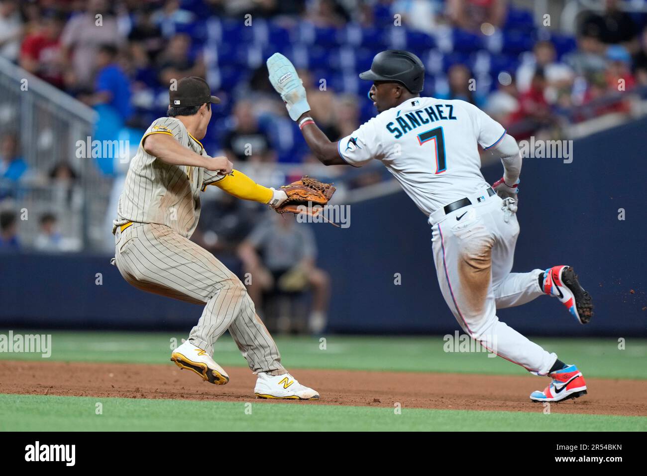 Miami Marlins' Jesus Sanchez is out at third as he attempt to avoid the
