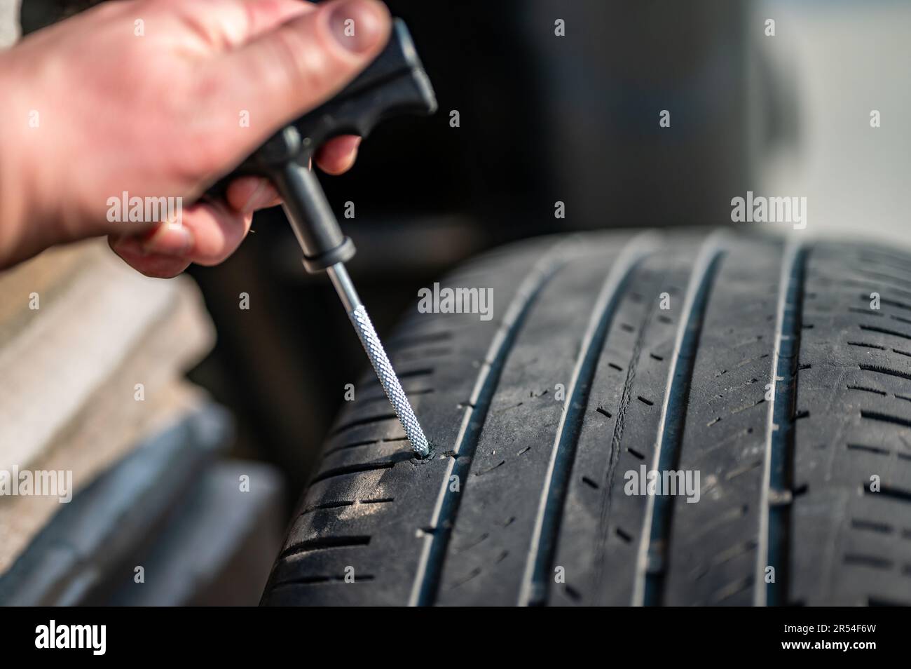 Reaming tool used to scarify and enlarge a tire puncture before