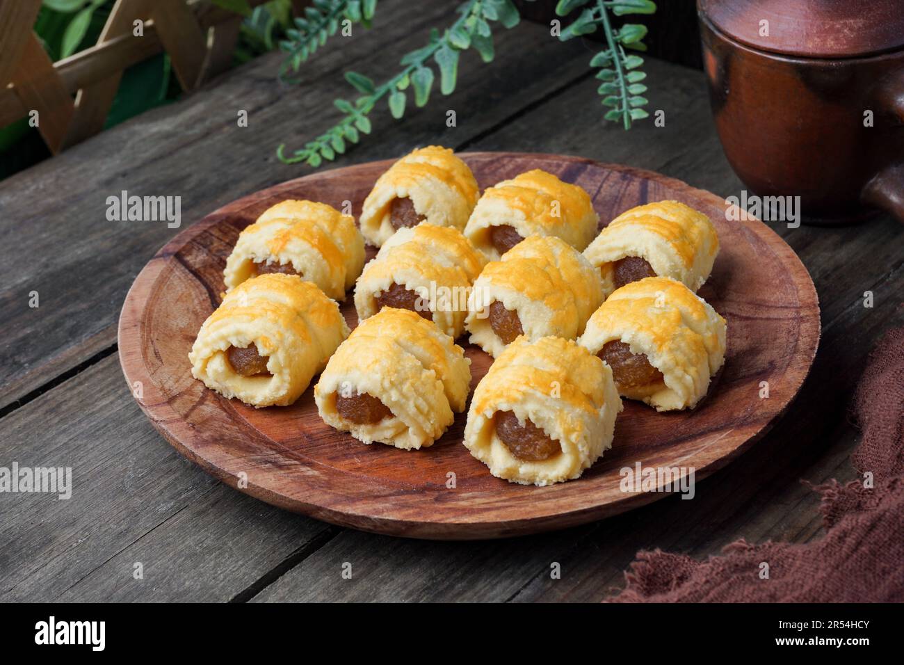 Pineapple Tart Roll cookies or Malay named Tart Nanas Gulung on dark background Stock Photo