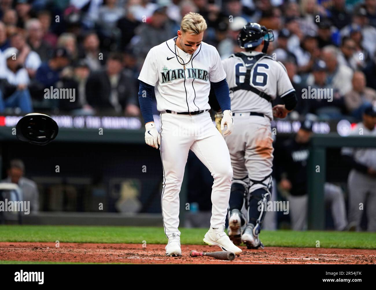 Seattle Mariners' Jarred Kelenic bounces his helmet off the ground