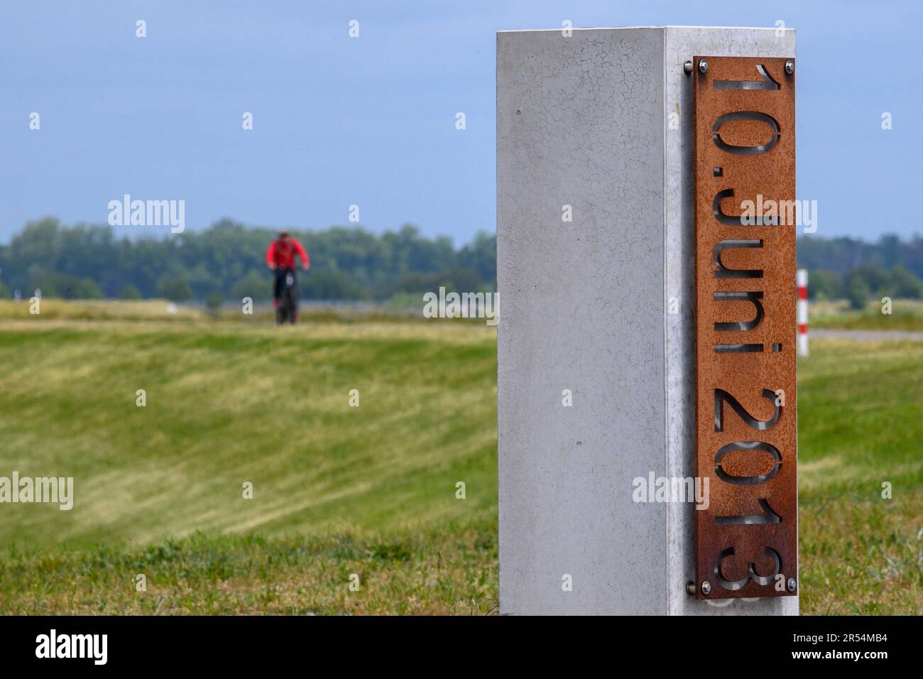 Wust Fischbeck, Germany. 18th May, 2023. '10 June 2013' can be read on a memorial stone on the dike near Fischbeck. On June 10, 2013, the June flood breached the dike near Fischbeck and flooded more than 150 square kilometers, affecting Brandenburg as well. (to dpa 'It's over' and yet not quite - Ten years of flooding') Credit: Klaus-Dietmar Gabbert/dpa/Alamy Live News Stock Photo