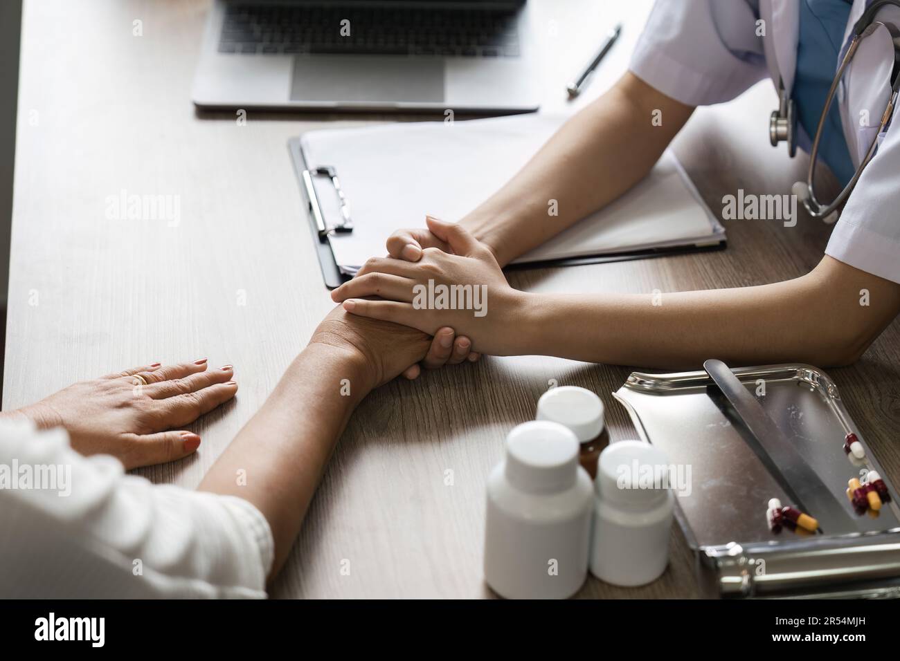 Trusting A Doctor Hand of doctor reassuring her senior female patient. Medical ethics and ...