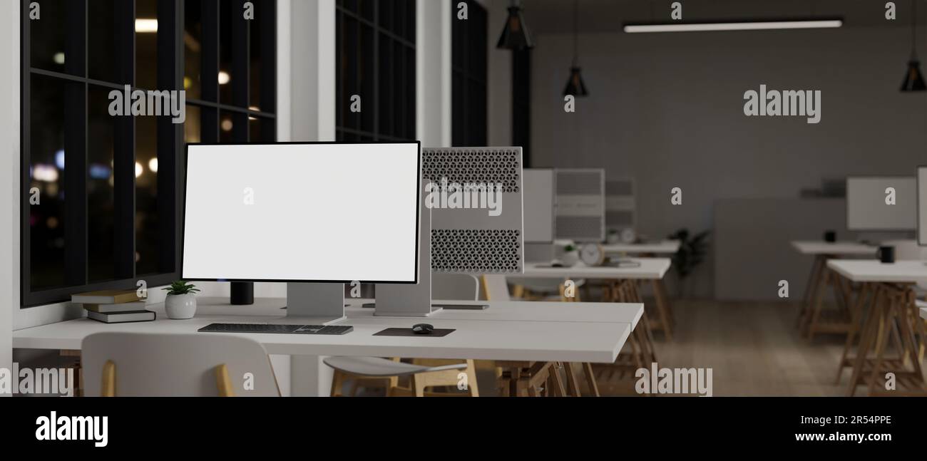 A computer white screen mockup on a white table in a modern office with