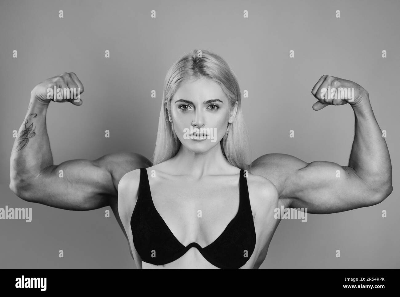 Girl shows her muscles strength Black and White Stock Photos & Images -  Alamy
