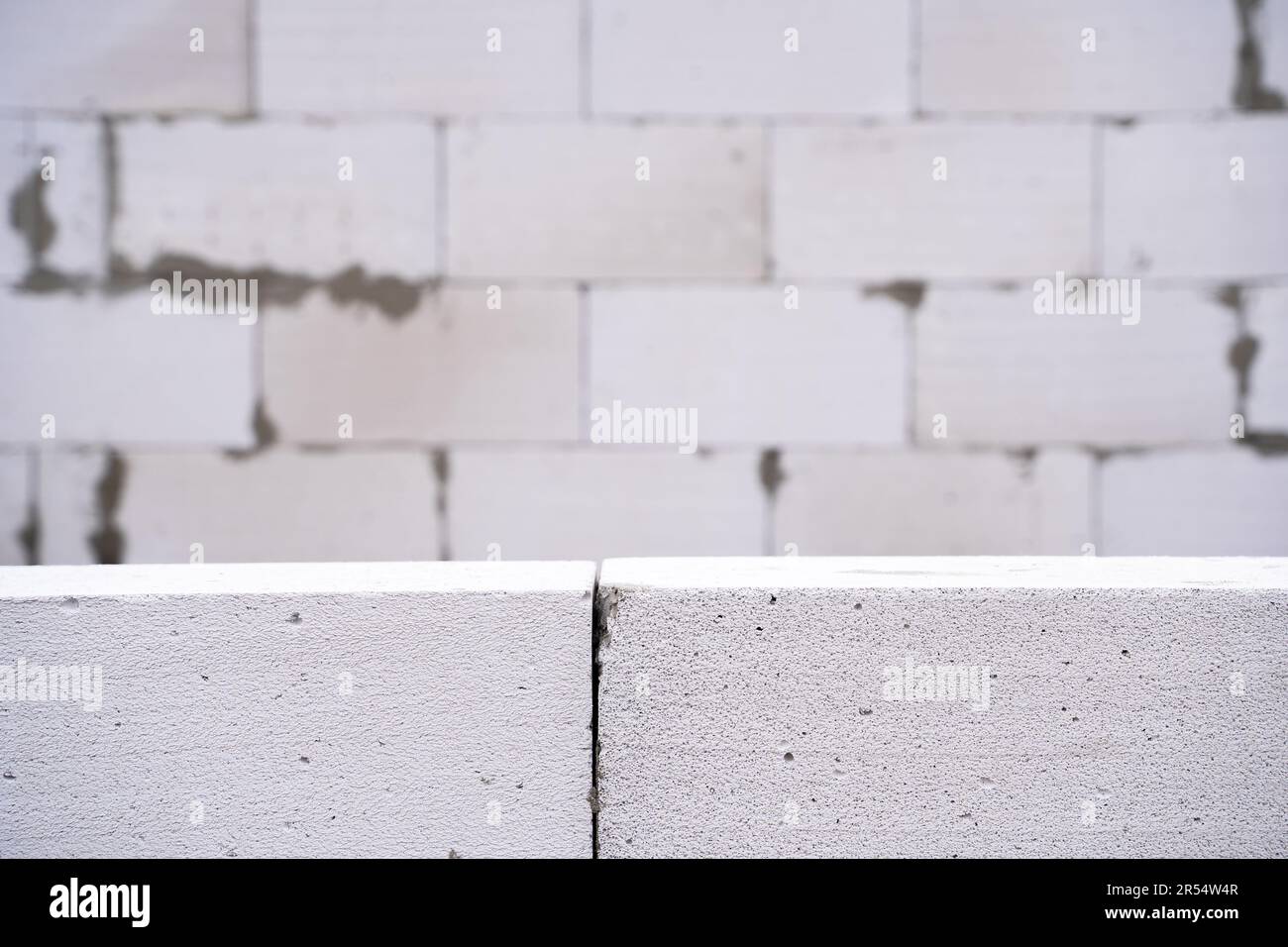 Background wallpaper from a wall of aerated concrete bricks. Aerated
