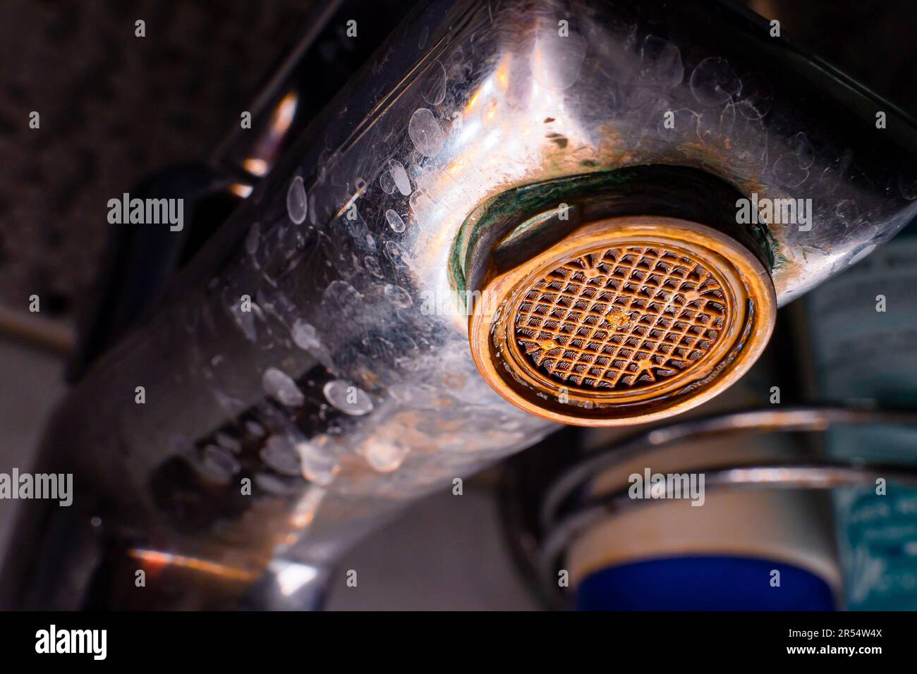 The diffuser in the faucet is clogged and corroded closeup. Old
