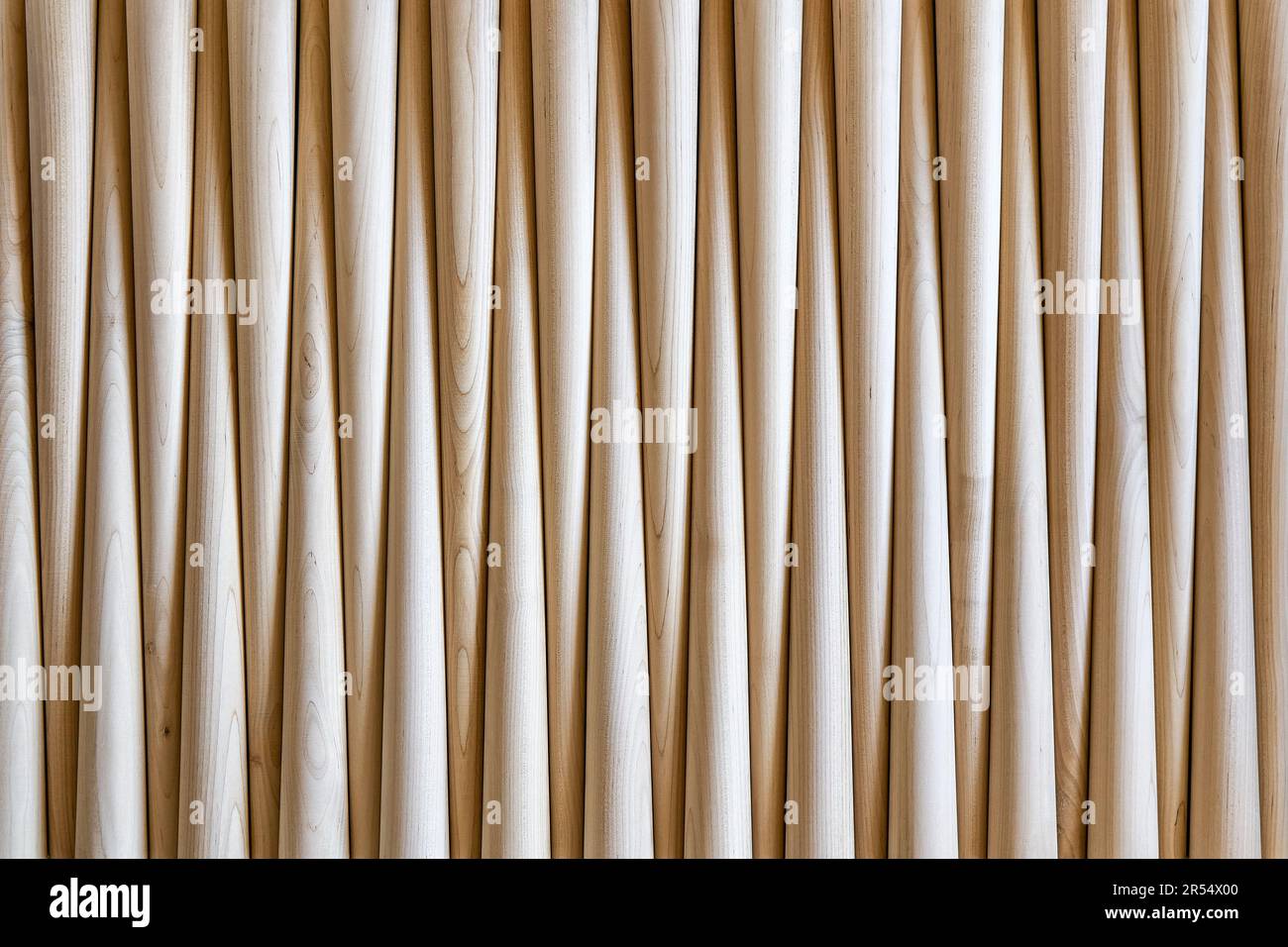 Pattern of polished conical wooden table legs as background upper view. Prepared furniture details in furniture manufacturing workshop Stock Photo