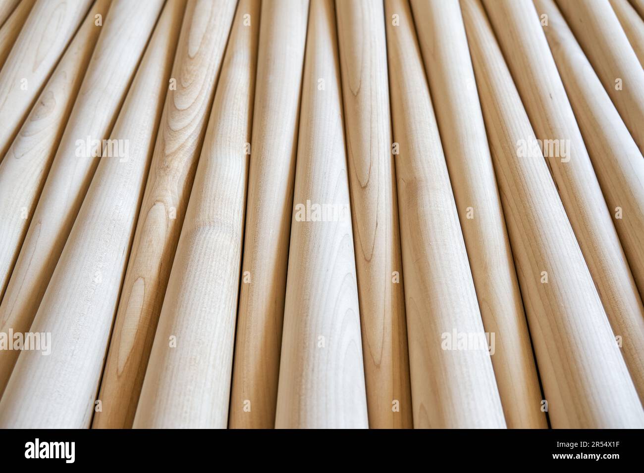 Pattern of polished conical wooden table legs as background upper view. Prepared furniture details in furniture manufacturing workshop Stock Photo