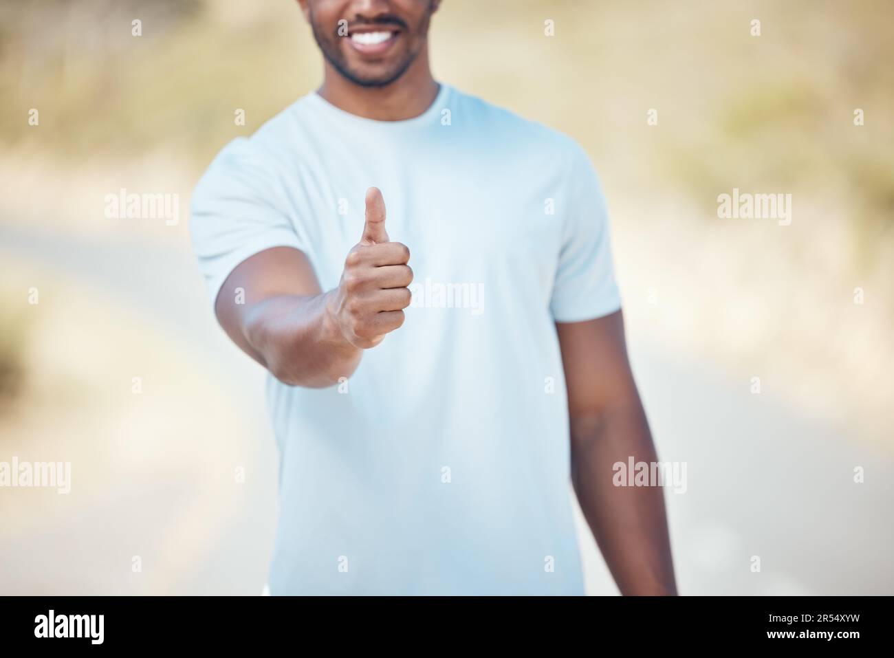 Man fitness and hand with thumbs up in nature for exercise