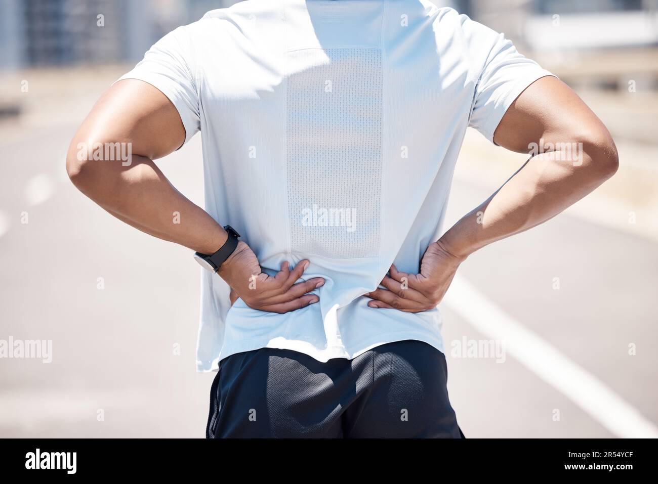 Back pain, sport injury and person with muscle, inflammation and accident from fitness. Outdoor