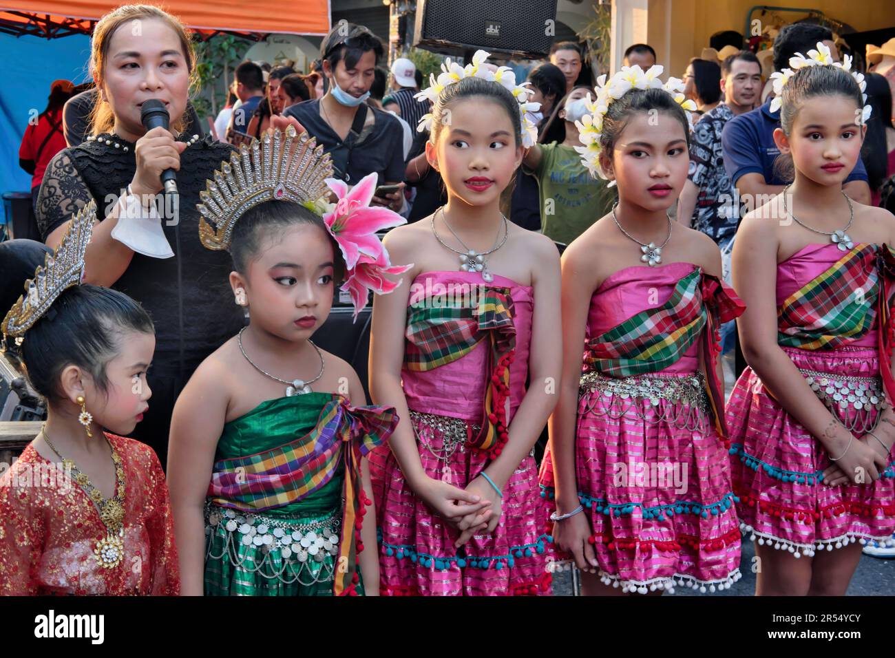 Thai school girls in traditional costume about to perform a traditional dance during the Sunday Walking Street Market in Phuket Town, Phuket, Thailand Stock Photo