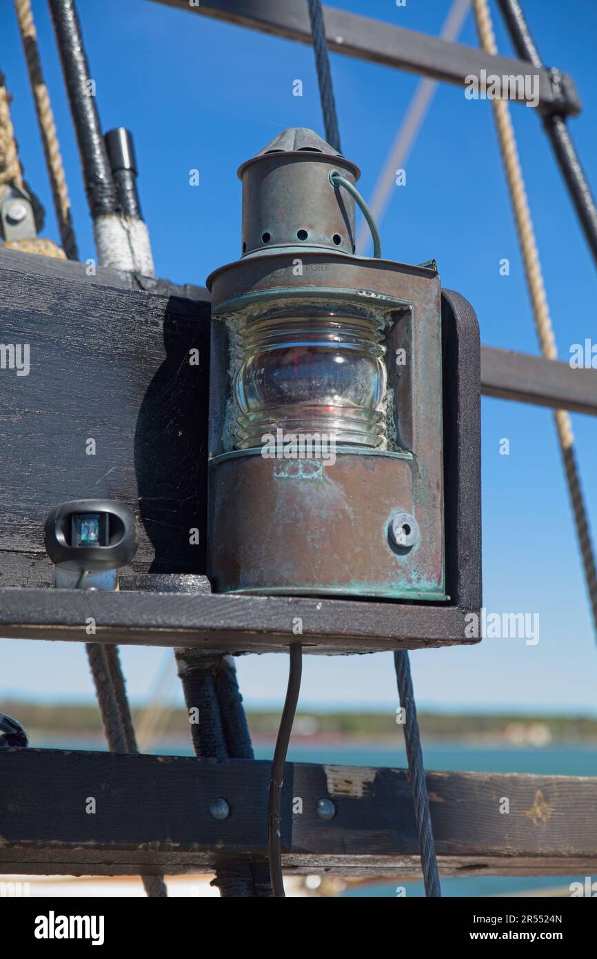 Vintage red port side navigational light on a old wooden sailing ship