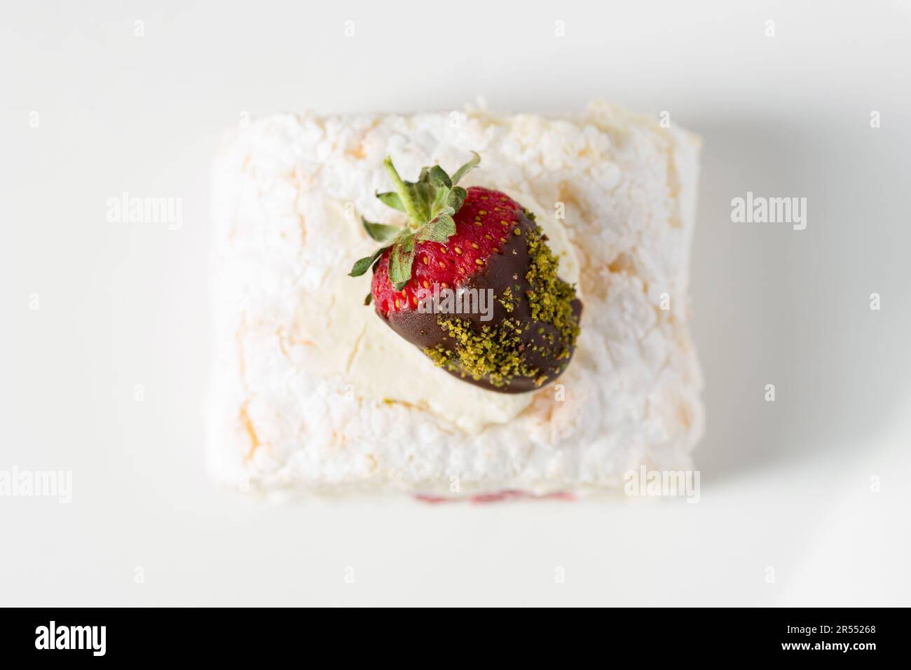 Strawberry roll cake with tea next to it on stone table Stock Photo