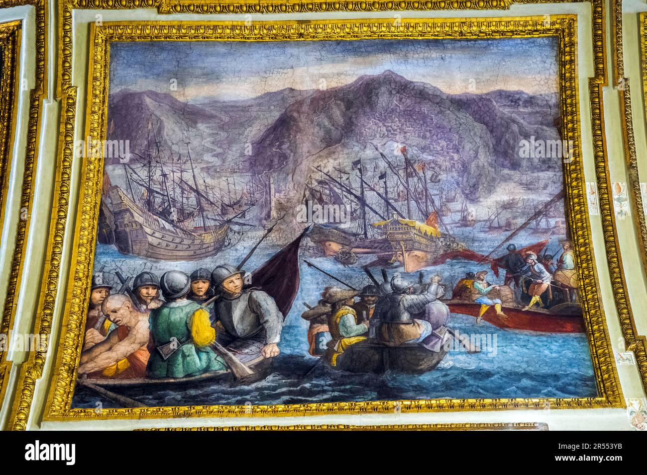 Painted ceiling framed by gilded stucco mouldings and inscriptions depicting the Spanish Reinforcements to Genoa under Siege by French - The ambassador's Hall in the Royal Palace of Naples that In 1734 became the royal residence of the Bourbons - Naples, Italy Stock Photo