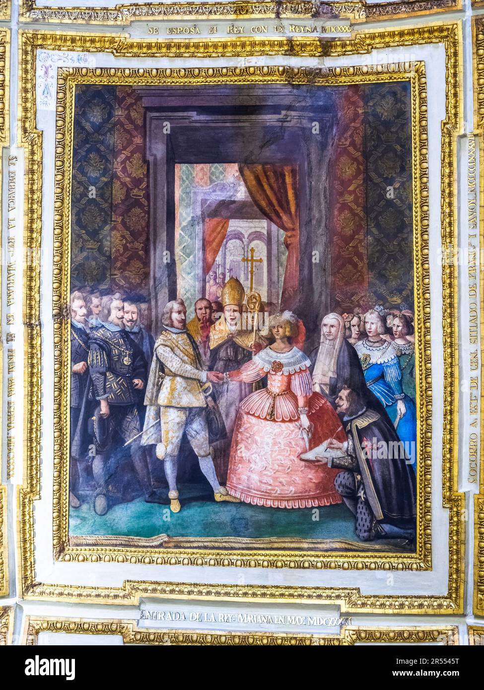 Painted ceiling framed by gilded stucco mouldings and inscriptions depicting the Wedding of Marianne to Philip III of Spain - The ambassador's Hall in the Royal Palace of Naples that In 1734 became the royal residence of the Bourbons - Naples, Italy Stock Photo