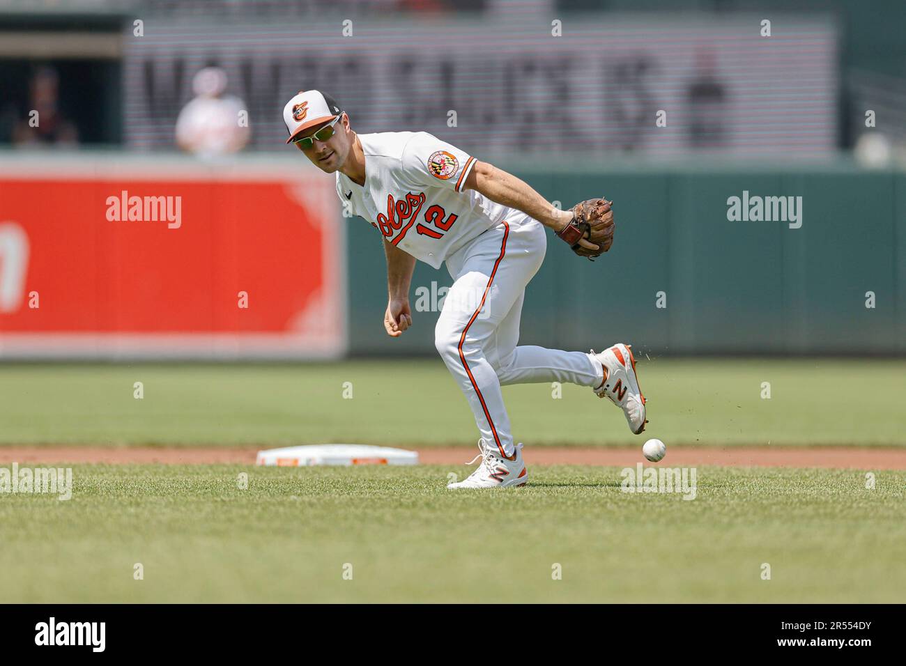 Baltimore Orioles second baseman Adam Frazier (12) safely reaches third  base after a wild pitch was thrown in the bottom of the second inning  against the Tampa Bay Rays at Oriole Park