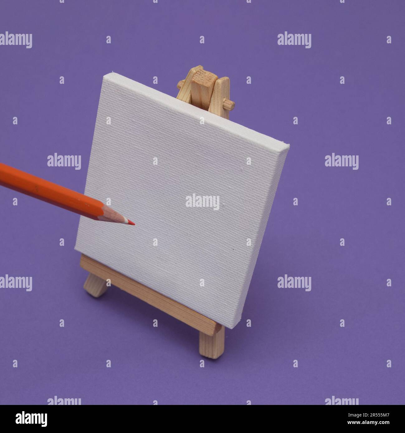 Canvas easel with canvas and pencil for drawing on a purple background. Minimal painting scenes