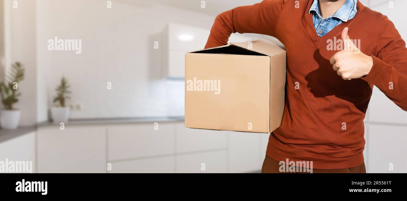 Man lifting cardboard boxes in apartment interior Stock Photo - Alamy