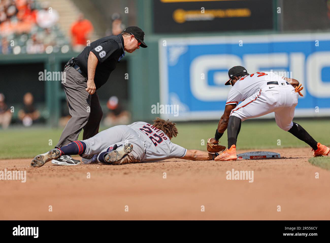 Baltimore, MD, USA; Cleveland Guardians first baseman Josh Naylor (22) slides back into second base and under the tag of Baltimore Orioles shortstop J Stock Photo