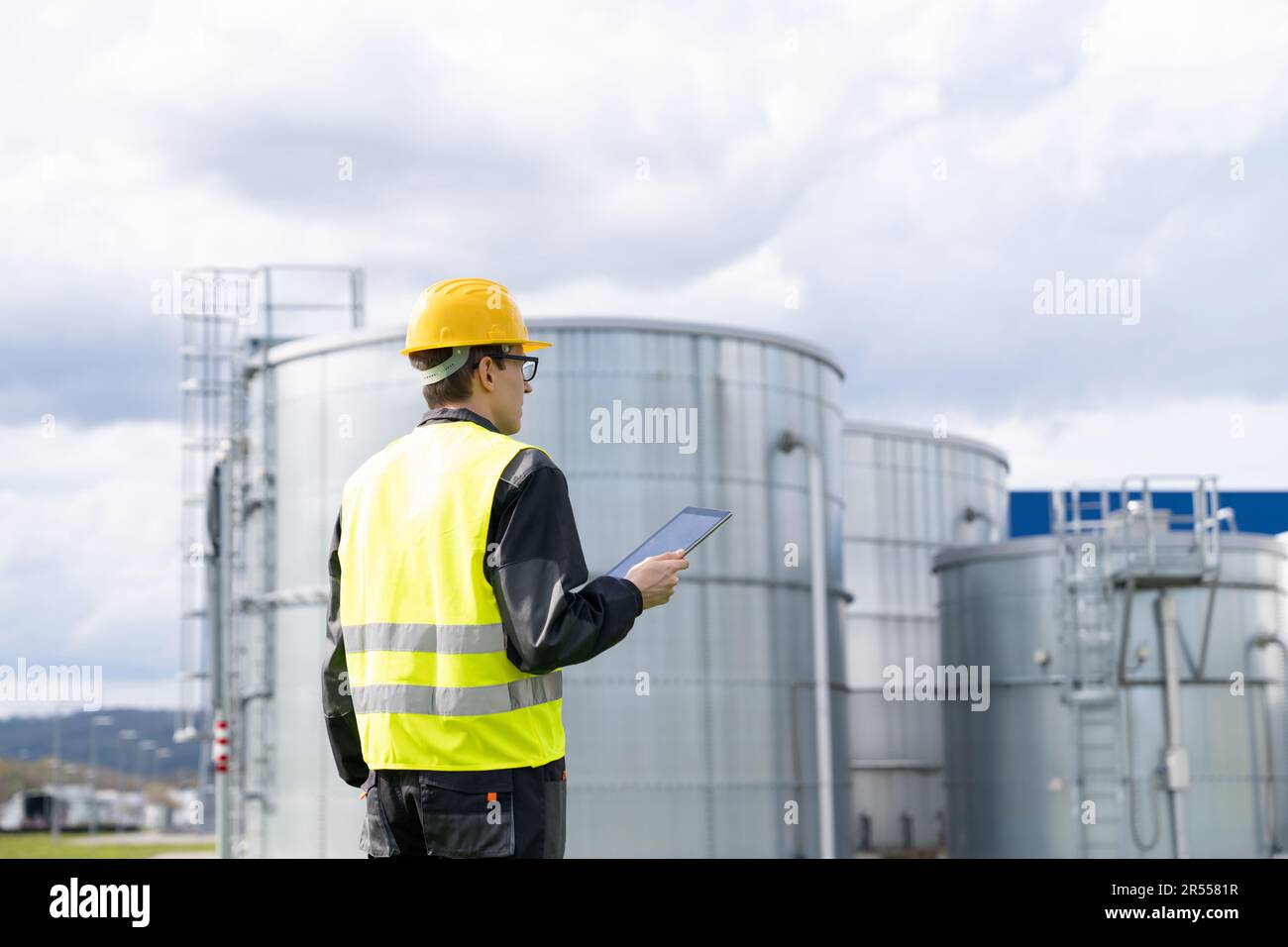 Engineer with digital tablet on a background of gas tanks. High quality photo Stock Photo