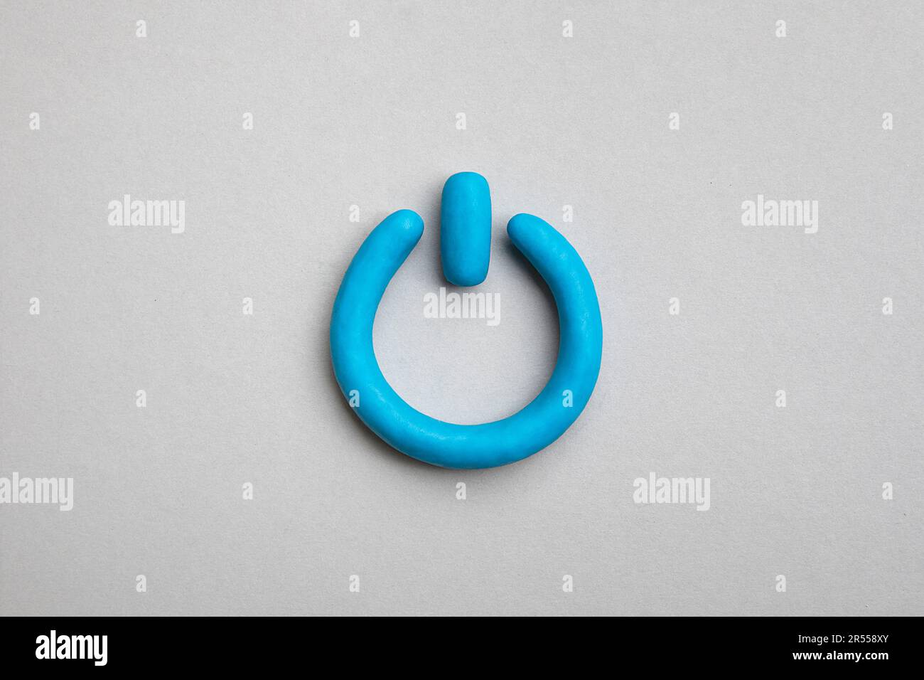 3d plasticine blue start icon on yellow background. Power on off, switch or start and stop button concept. Stock Photo