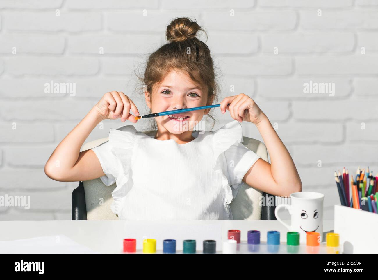 https://c8.alamy.com/comp/2R559RF/funny-kids-emotions-cute-little-preschooler-child-girl-drawing-at-school-child-girl-painting-on-elementary-school-kids-early-arts-and-crafts-2R559RF.jpg