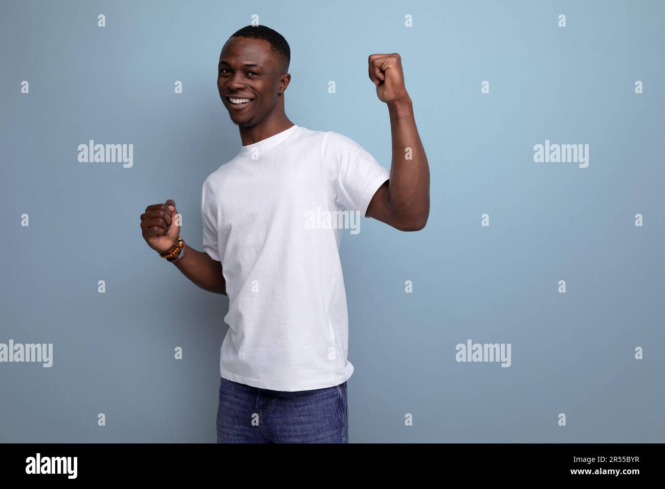 positive attractive young american guy in white t-shirt smiling on ...