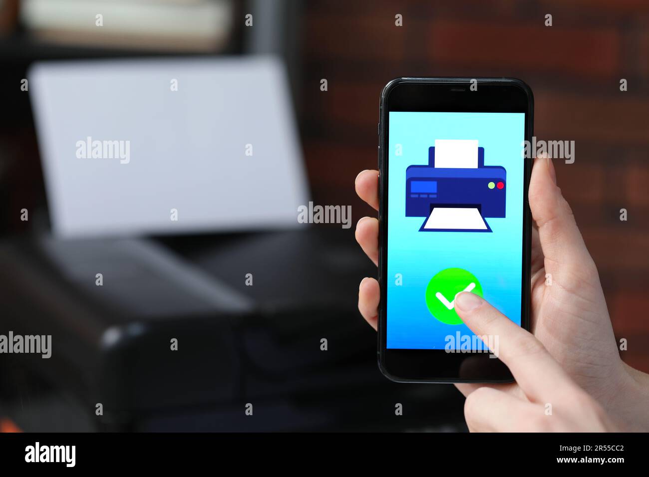 Man using printer management application on mobile phone indoors, closeup and space for text Stock Photo