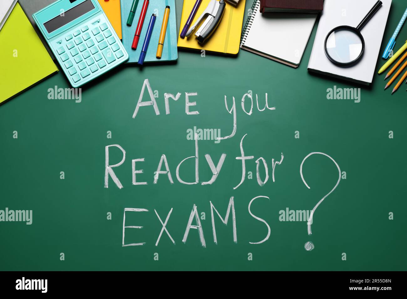 Green chalkboard with phrase Are You Ready For Exams and different stationery, flat lay Stock