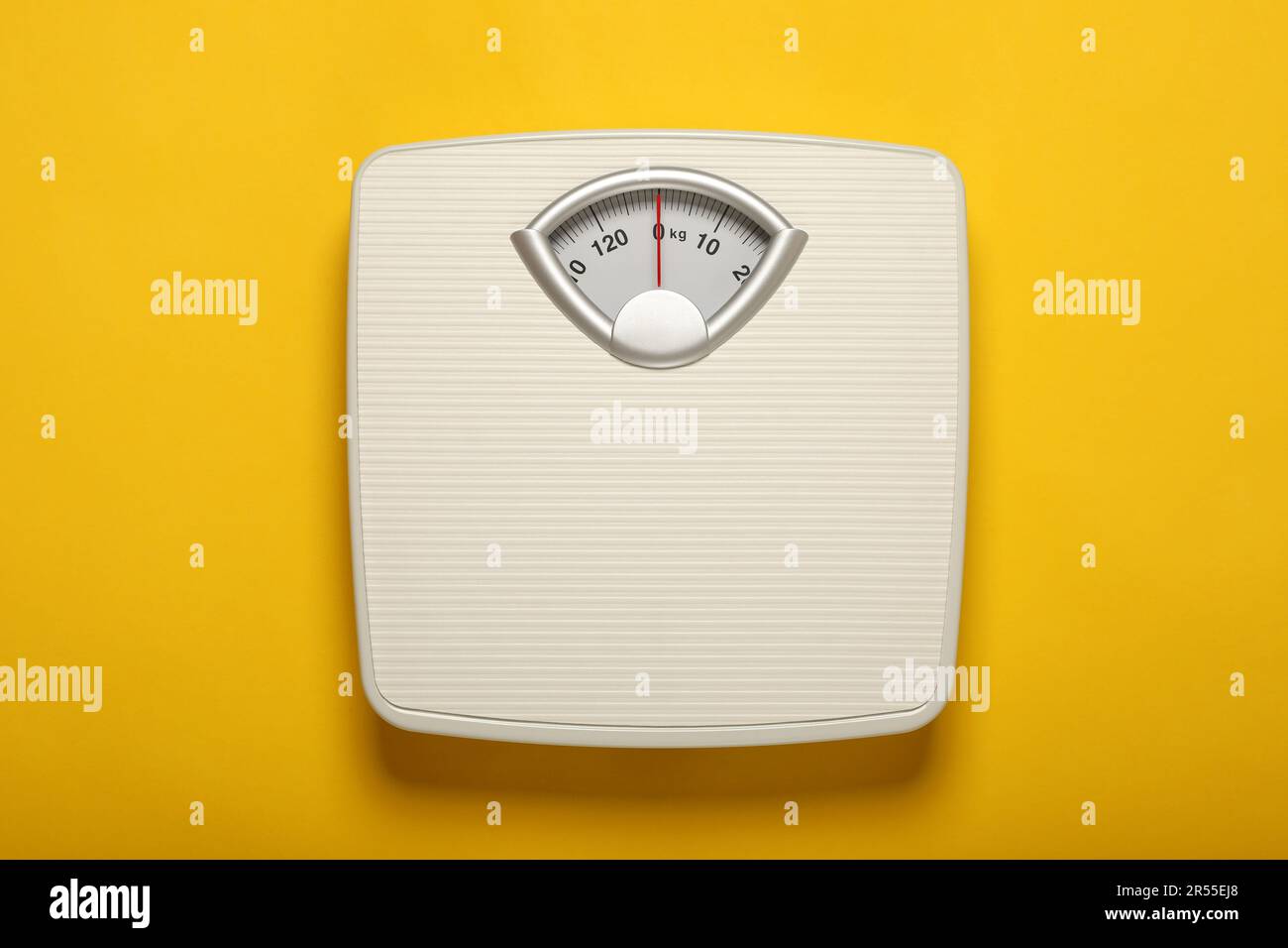 https://c8.alamy.com/comp/2R55EJ8/weigh-scales-on-yellow-background-top-view-overweight-concept-2R55EJ8.jpg