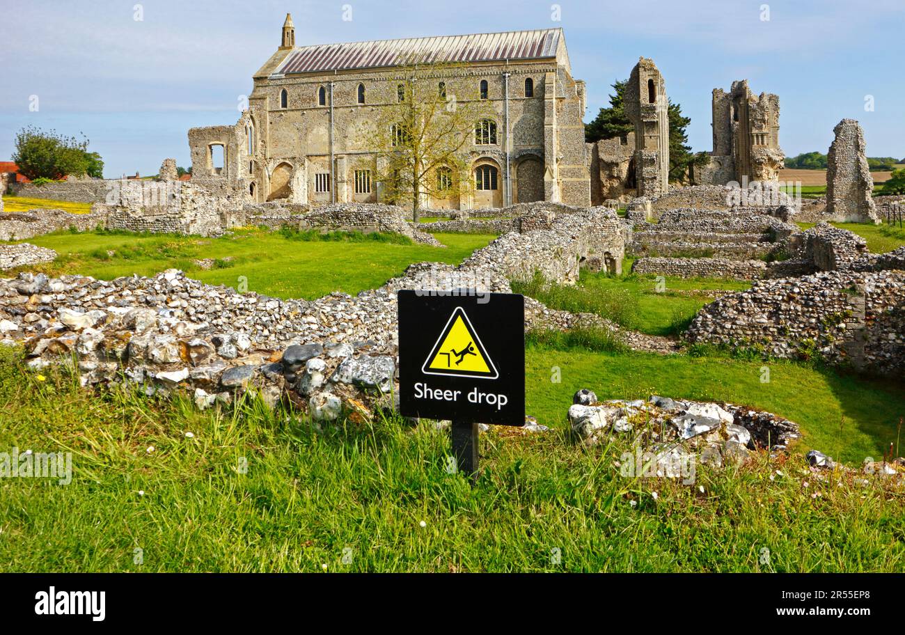 A Sheer Drop safety notice within the confines of the ruins and Priory Church of St Mary and the Holy Cross at Binham, Norfolk, England, UK. Stock Photo