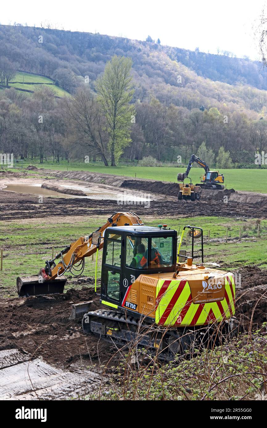 Heavy machinery landscaping area to create a pond for a nature reserve Stock Photo