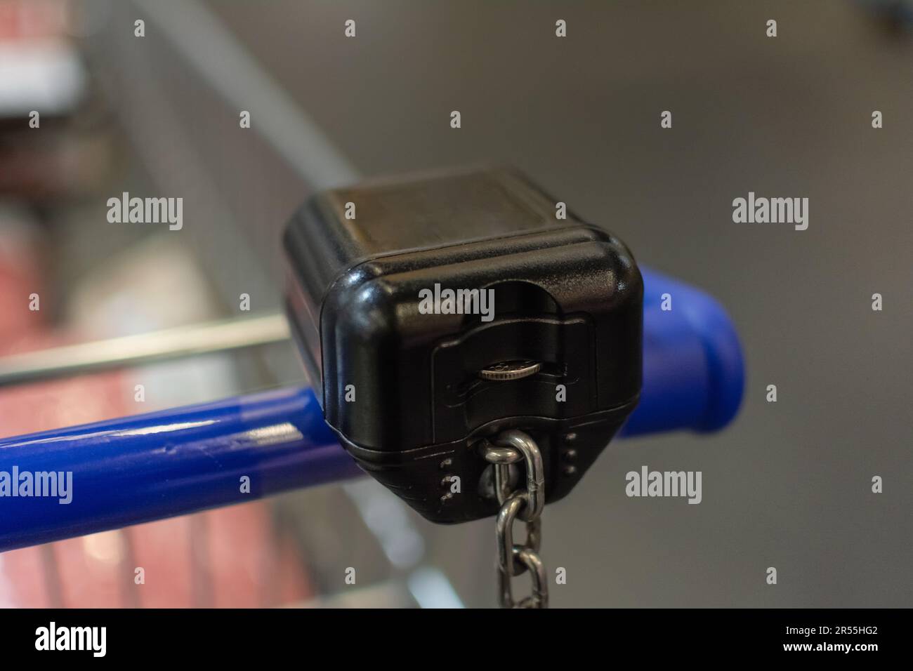 Shopping cart with a coin operated locking system. The coin receiving