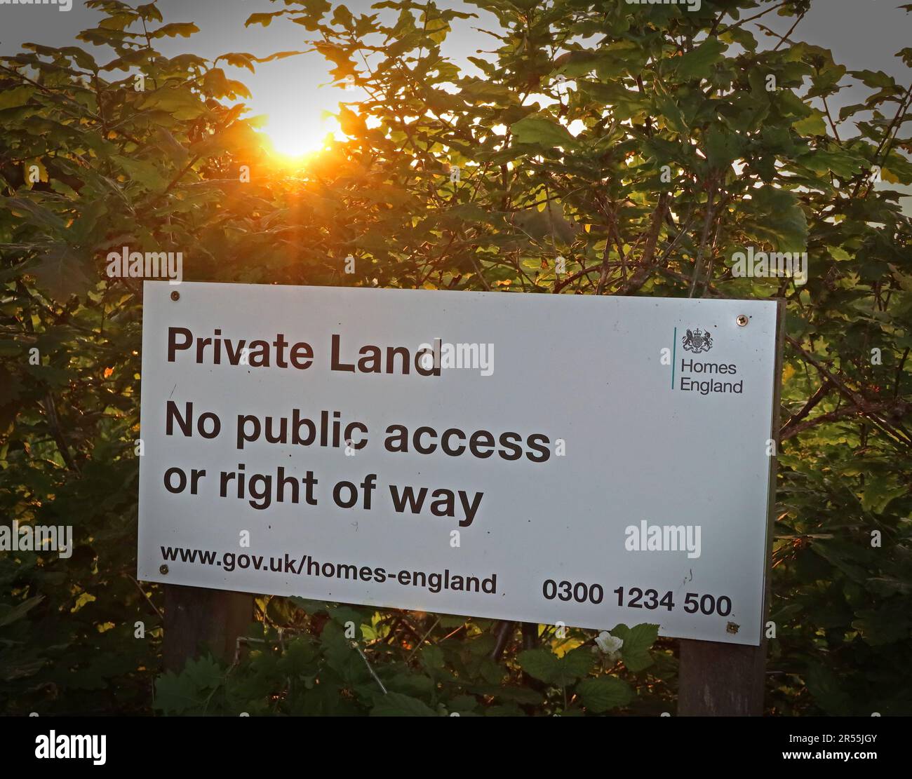 Homes England sign stating “Private Land. No public access or right of way” photographed at sunset in Grappenhall, Cheshire Stock Photo