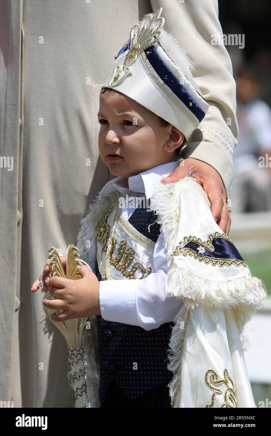 ISTANBUL, TURKEY - JUNE 13, 2009 : A beautifully dressed young Turkish boy prior to his sunnet (circumcision) ceremony stands outside the Eyup Sultan Stock Photo