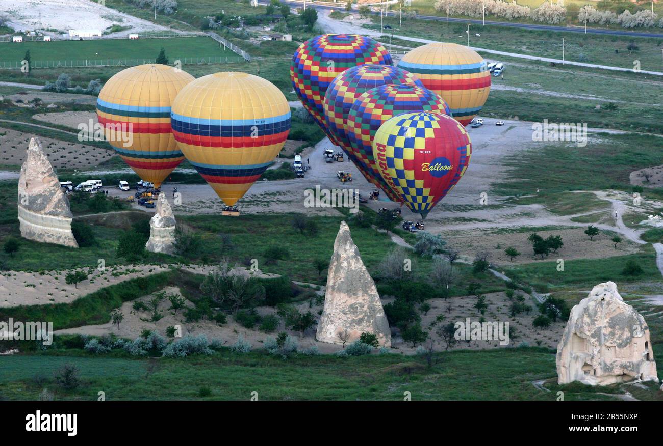 GOREME, TURKIYE - MAY 25, 2009 : Colourful hot air balloons prepare for take-off at Goreme in the Cappadocia region of Turkey. In the foreground are v Stock Photo