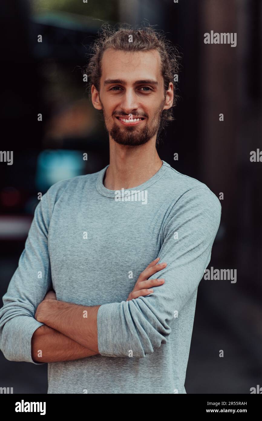 Portrait of a young successful businessman with crossed arms in front ...