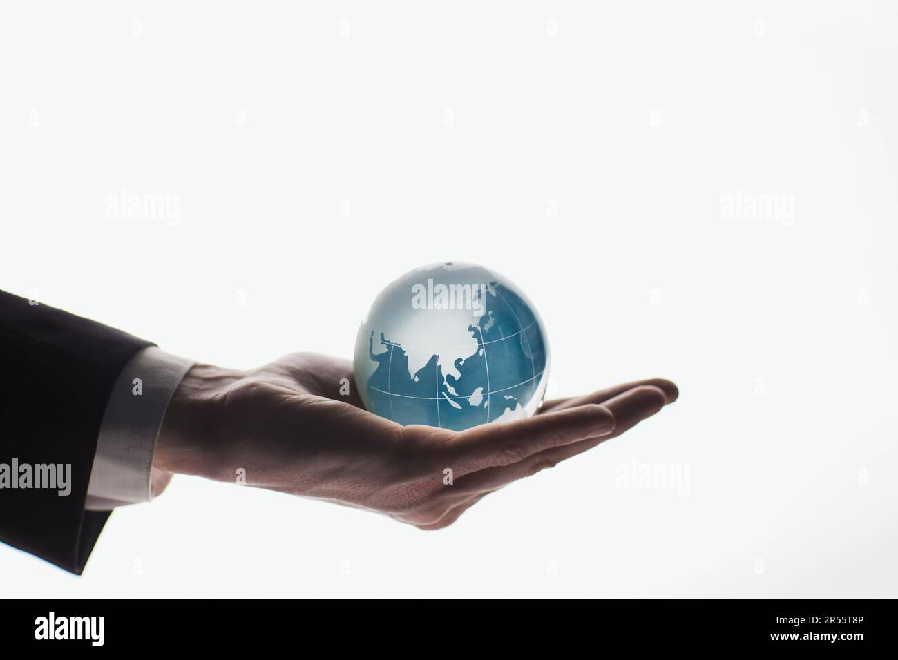 Businessman holding glass globe isolated on white background Stock ...