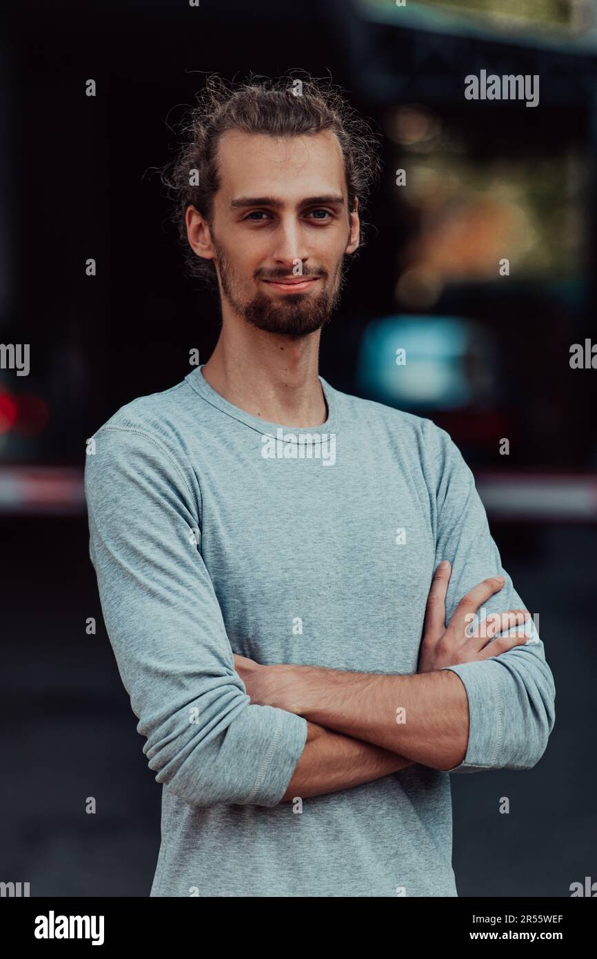 Portrait of a young successful businessman with crossed arms in front ...