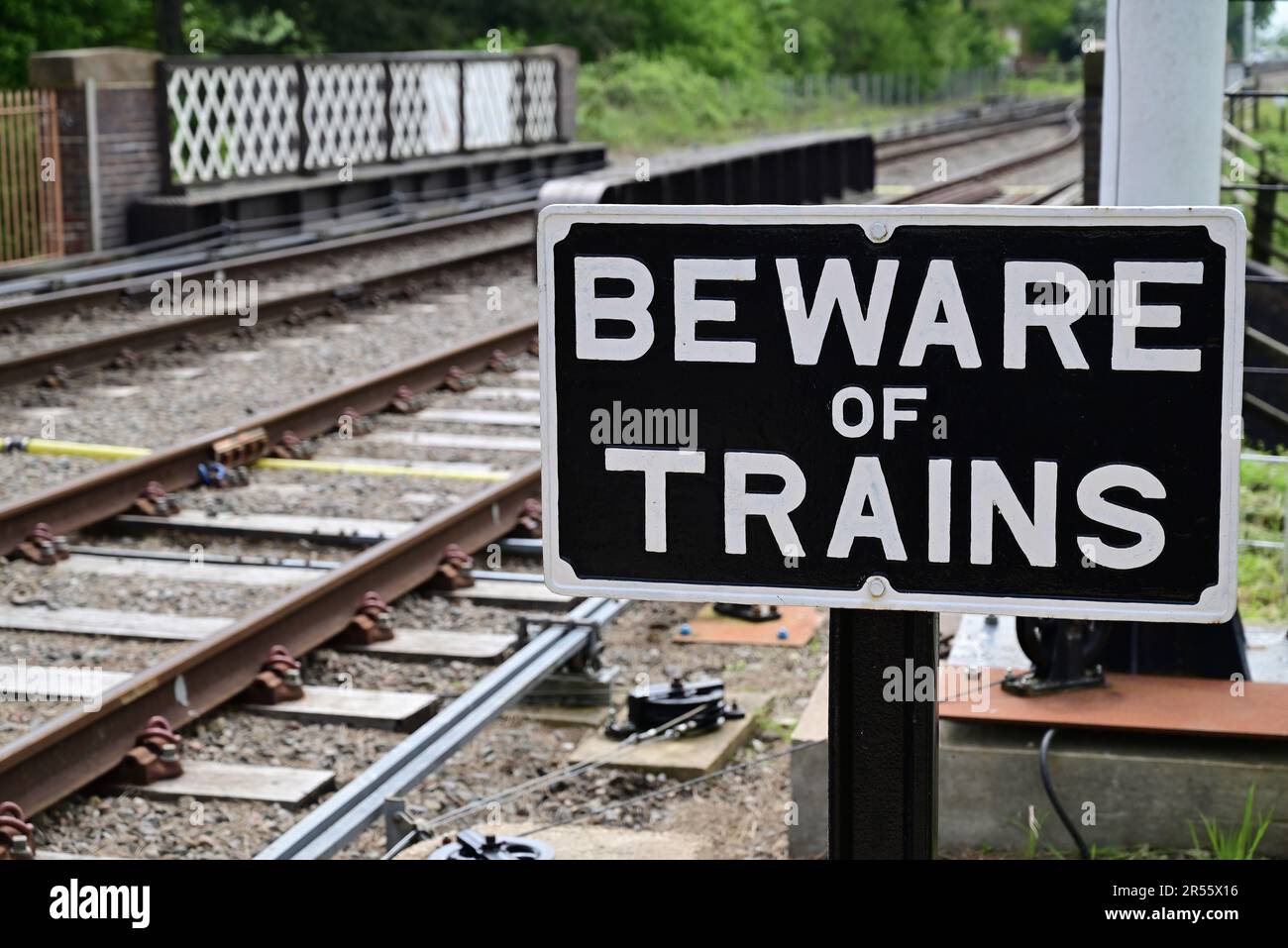Beware of Trains sign beside a foot crossing at Broadway station on the Gloucestershire Warwickshire Steam Railway. Stock Photo