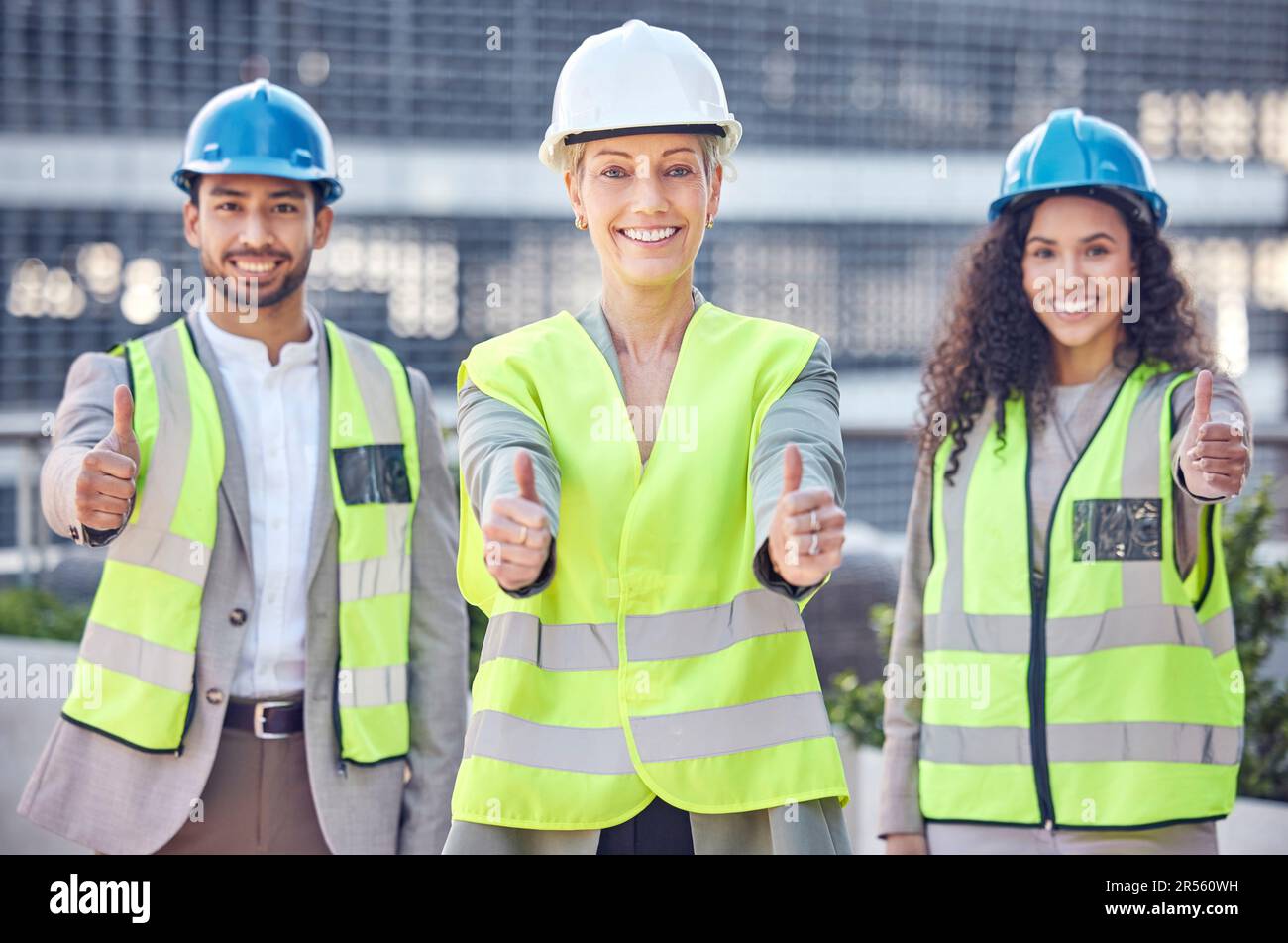 Engineer, construction and team thumbs up with a woman manager outdoor for civil engineering work. Portrait of leader and gender equality with a man Stock Photo