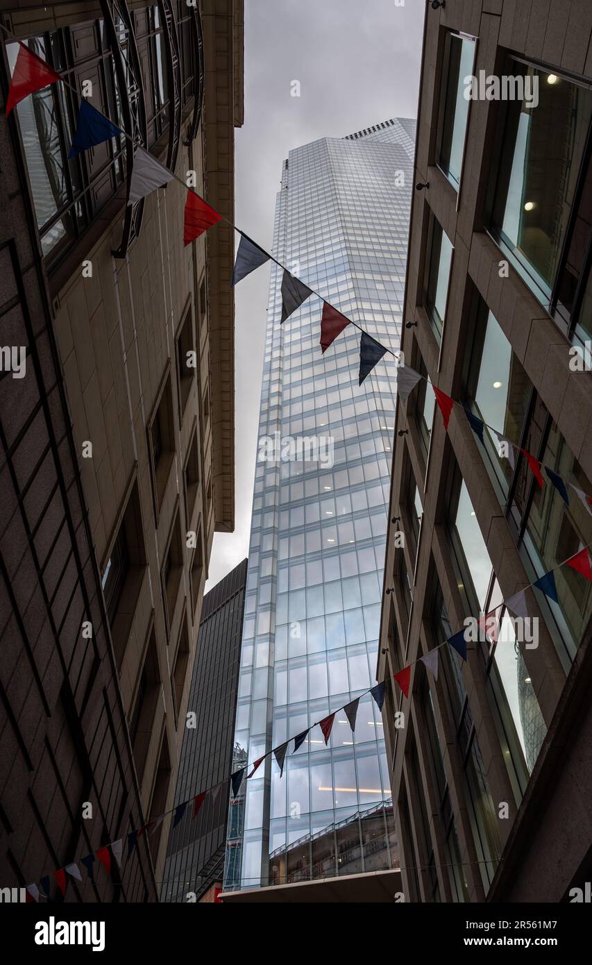 London, UK - May 10 2023: Looking up at 22 Bishopsgate or TwentyTwo in the City of London. Seen from an alley opposite with flags overhead. Stock Photo