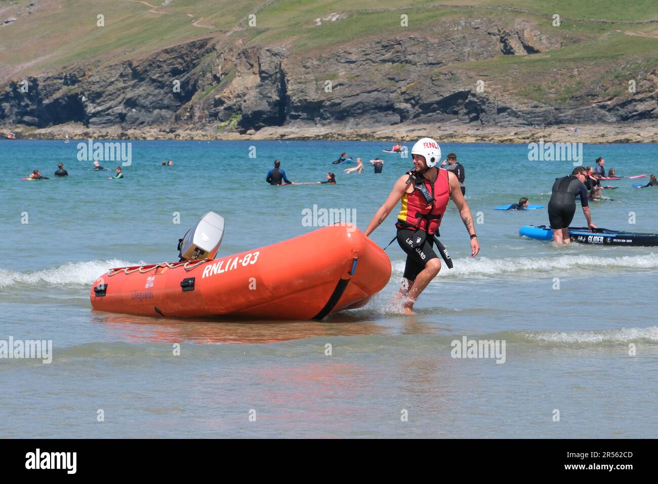 Polzeath, Cornwall, UK. 1st June 2023.  June 1st. the start of meteorlogical summer got off to a hot start with people heading for the beach and into the sea at Polzeath in Cornwall. The RNLI were out in the sea making sure surfers, swimmers and paddle boarders stayed safe.  Credit Simon Maycock / Alamy Live News. Stock Photo