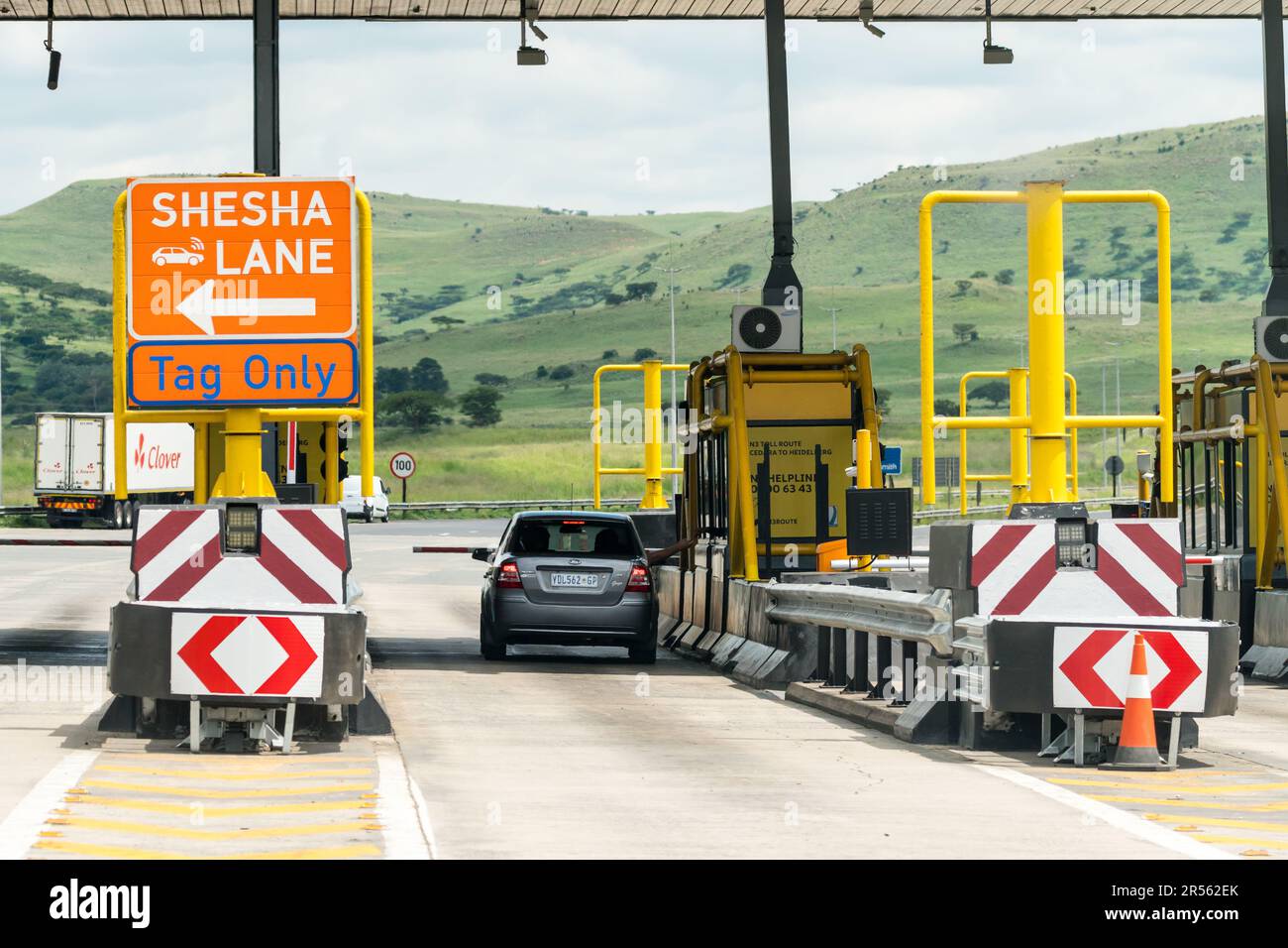 car and motorist paying for e tolls at toll plaza booth in South Africa