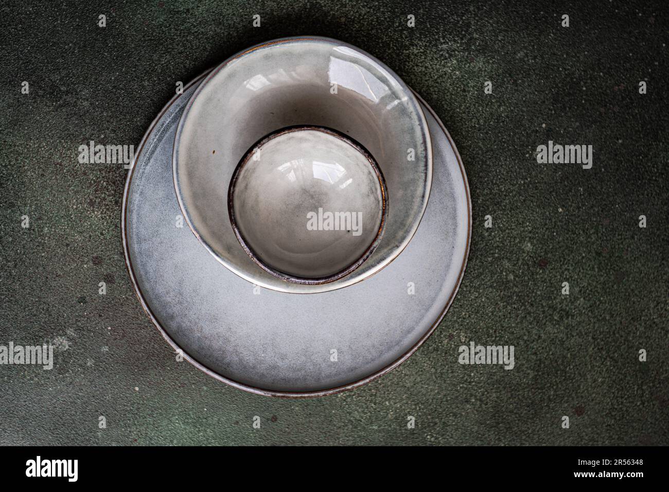 Overhead view of grey ceramic bowls and plates on a table Stock Photo