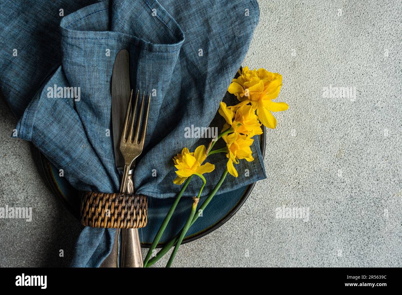 Overhead view of a spring place setting with daffodils Stock Photo