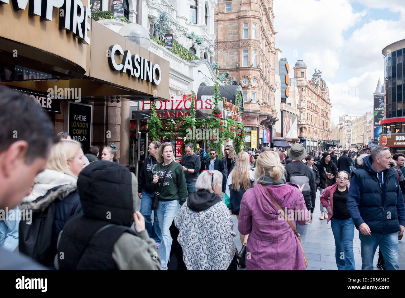London, United Kingdom - 04 07 2023: Tourists next to the Empire Casino, Leicester Square. Stock Photo