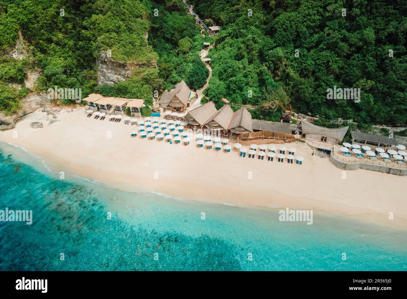 Aerial view of ocean and luxury beach resort with umbrellas in Bali Stock Photo