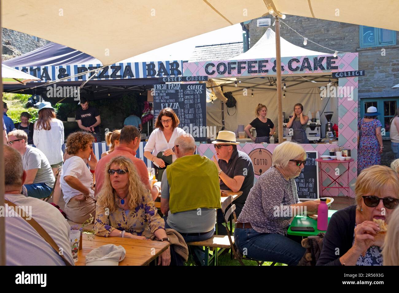 People sitting at Coffee Cake stall and Pizza Bar near Hay Castle in town centre during Hay Book Festival 2023 Hay-on-Wye Wales UK   KATHY DEWITT Stock Photo