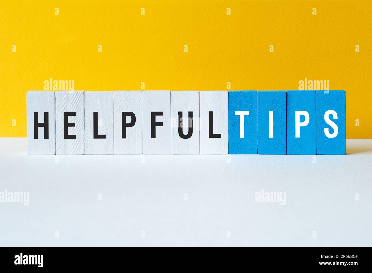 Helpful tips - word concept on building blocks, text Stock Photo